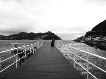People walking on pier