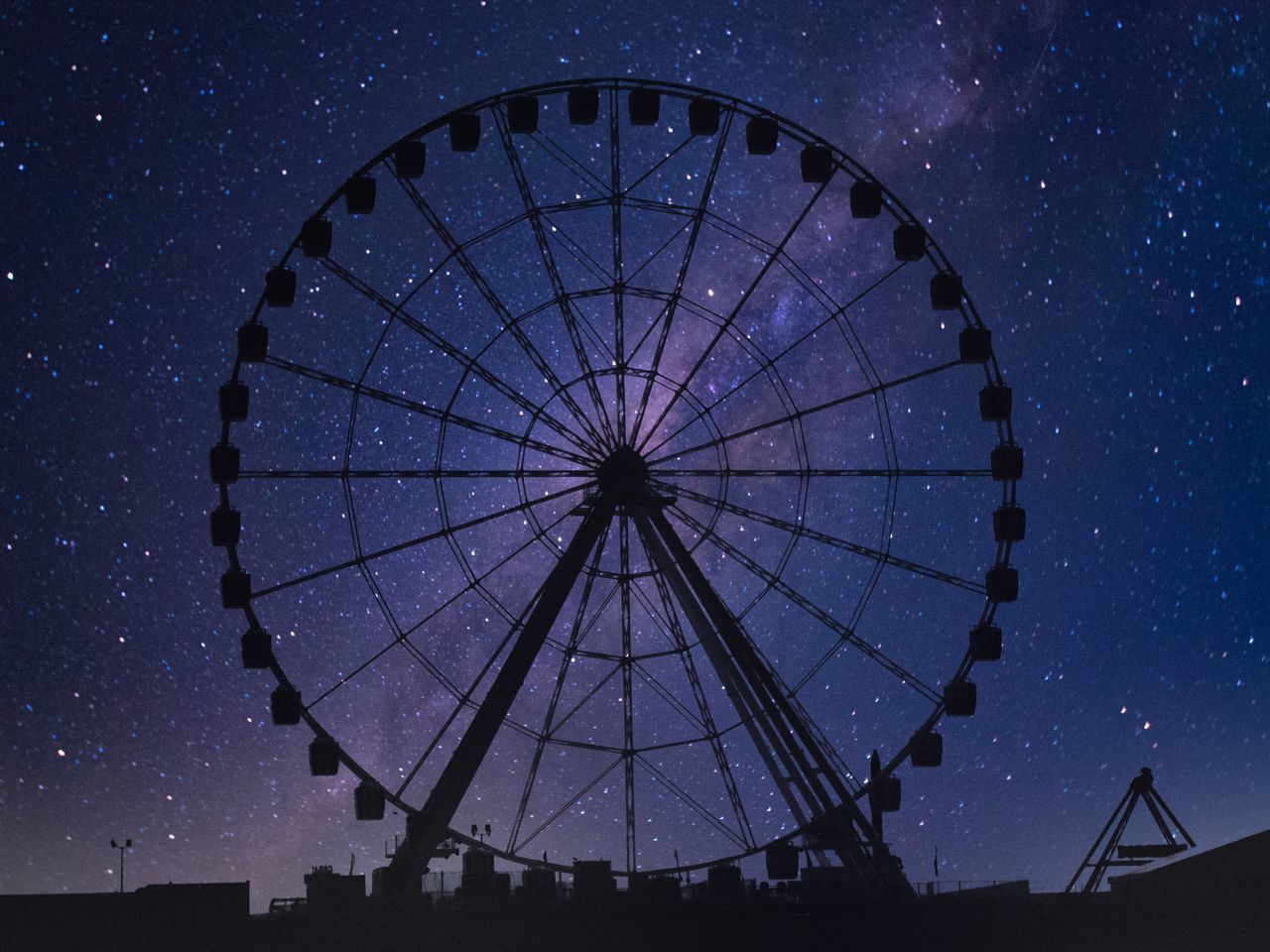 LOW ANGLE VIEW OF FERRIS WHEEL AGAINST BLUE SKY