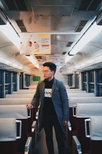 People standing on train at railroad station