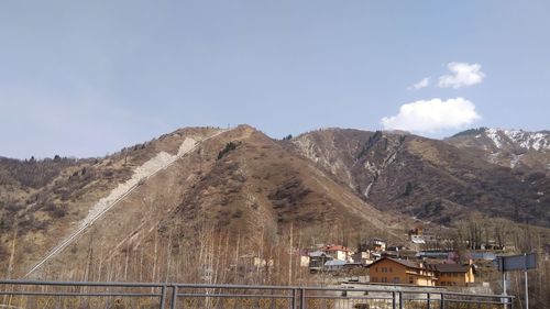 Houses on mountain against sky