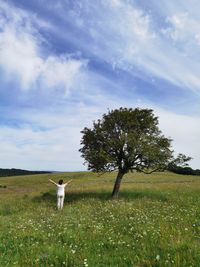 View of dog on field against sky