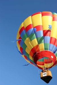 Low angle view of hot air balloon against blue sky