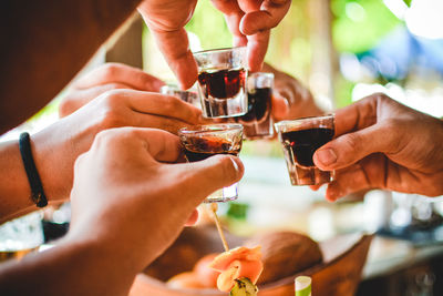 Close-up of hands doing shots