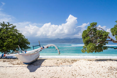 Scenic view of beach against blue sky