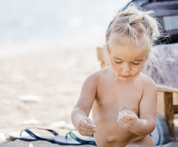 Naked girl sitting at beach