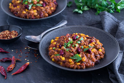 Bowls of delicious black bean and corn chili con carne, ready for eating.