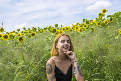 Portrait of a smiling young woman on field