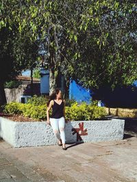 Full length of woman sitting outdoors