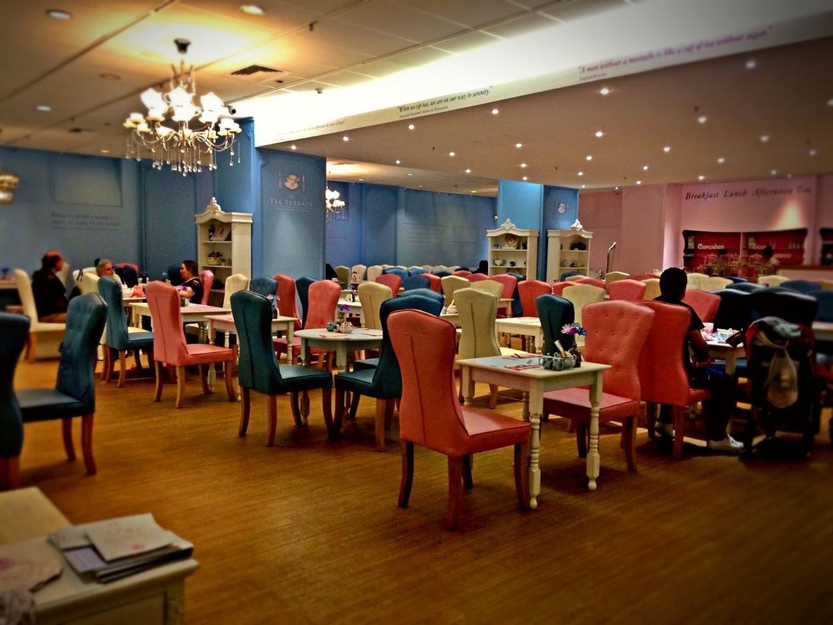 CHAIRS AND TABLE IN ILLUMINATED ROOM