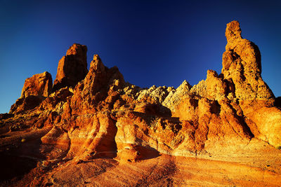 Rock formations at el teide national park against clear blue sky