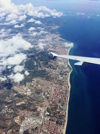 Aerial view of cityscape and sea against sky