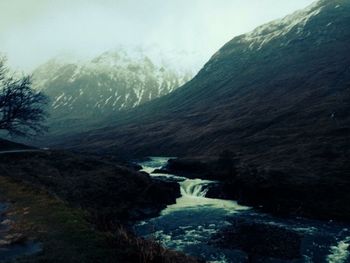 Scenic view of river flowing through rocks