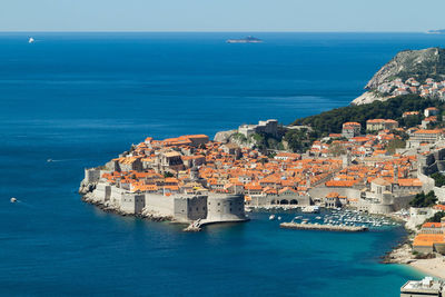 Scenic view of sea and buildings against sky