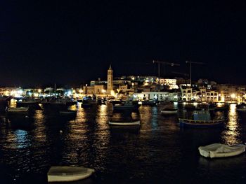 Boats in harbor at night