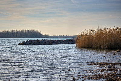 Frozen lake against sky during winter