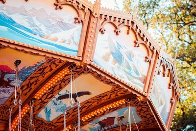 Low angle view of illuminated carousel against sky