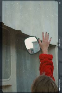 Rear view of woman hand in car