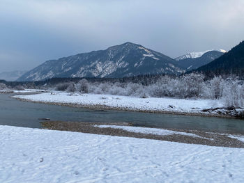 Scenic view of snowcapped mountains against sky during winter