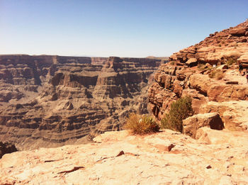 Rock formations on landscape against clear sky