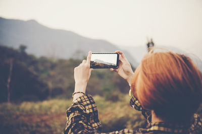 Man photographing with mobile phone