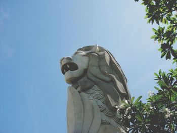 Low angle view of statue against clear blue sky