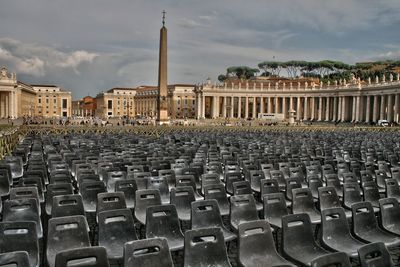 Chairs arranged against buildings