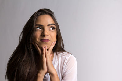 Portrait of a beautiful young woman over white background