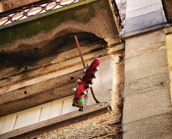 Full length of boy holding red umbrella