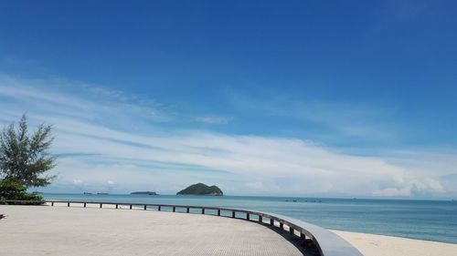 Scenic view of beach against blue sky