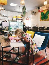 Girl sitting on table at home