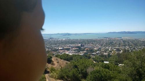 Scenic view of sea with cityscape in background