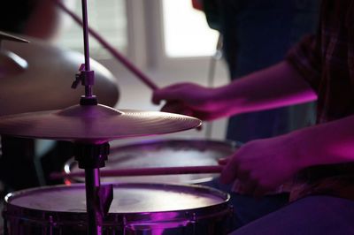 Cropped image of man playing drums