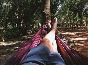 Low section of woman relaxing on hammock