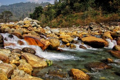 Scenic view of river flowing through rocks