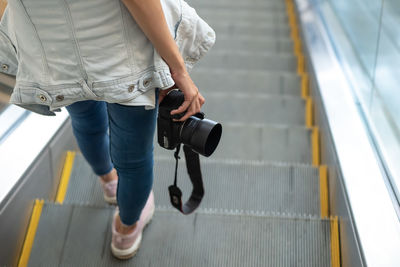 Low section of woman standing on staircase