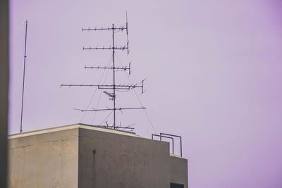 Low angle view of communications tower against sky