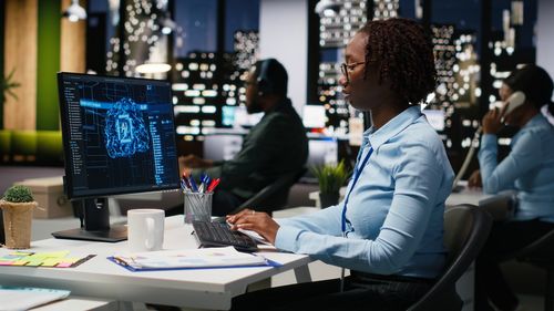 Side view of business colleagues working at office