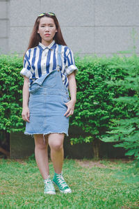 Portrait of young woman standing against outdoors