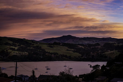 Scenic view of silhouette mountains against sky at sunset