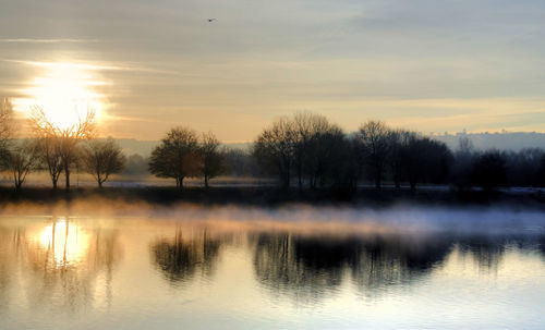 Scenic view of lake at sunset