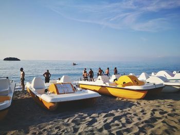 People on beach against sky