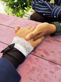 High angle view of man holding hands on table