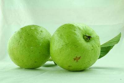 Close-up of apple on table against white background