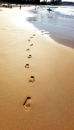 Footprints on sand at beach