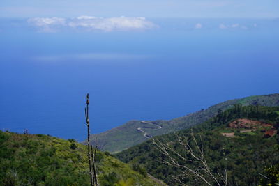 Scenic view of mountains against blue sky