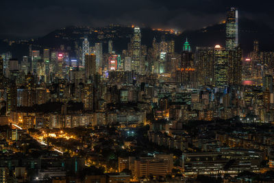 Illuminated cityscape against sky at night