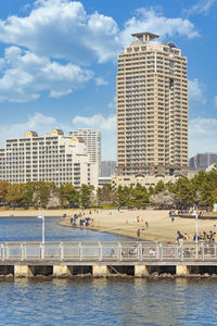 Seascape of the pontoon of odaiba marine park with skyscrapers buildings in the back.