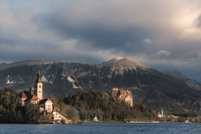 Church by sea against mountain