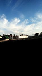 Silhouette of train against blue sky
