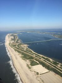 Aerial view of sea against clear blue sky